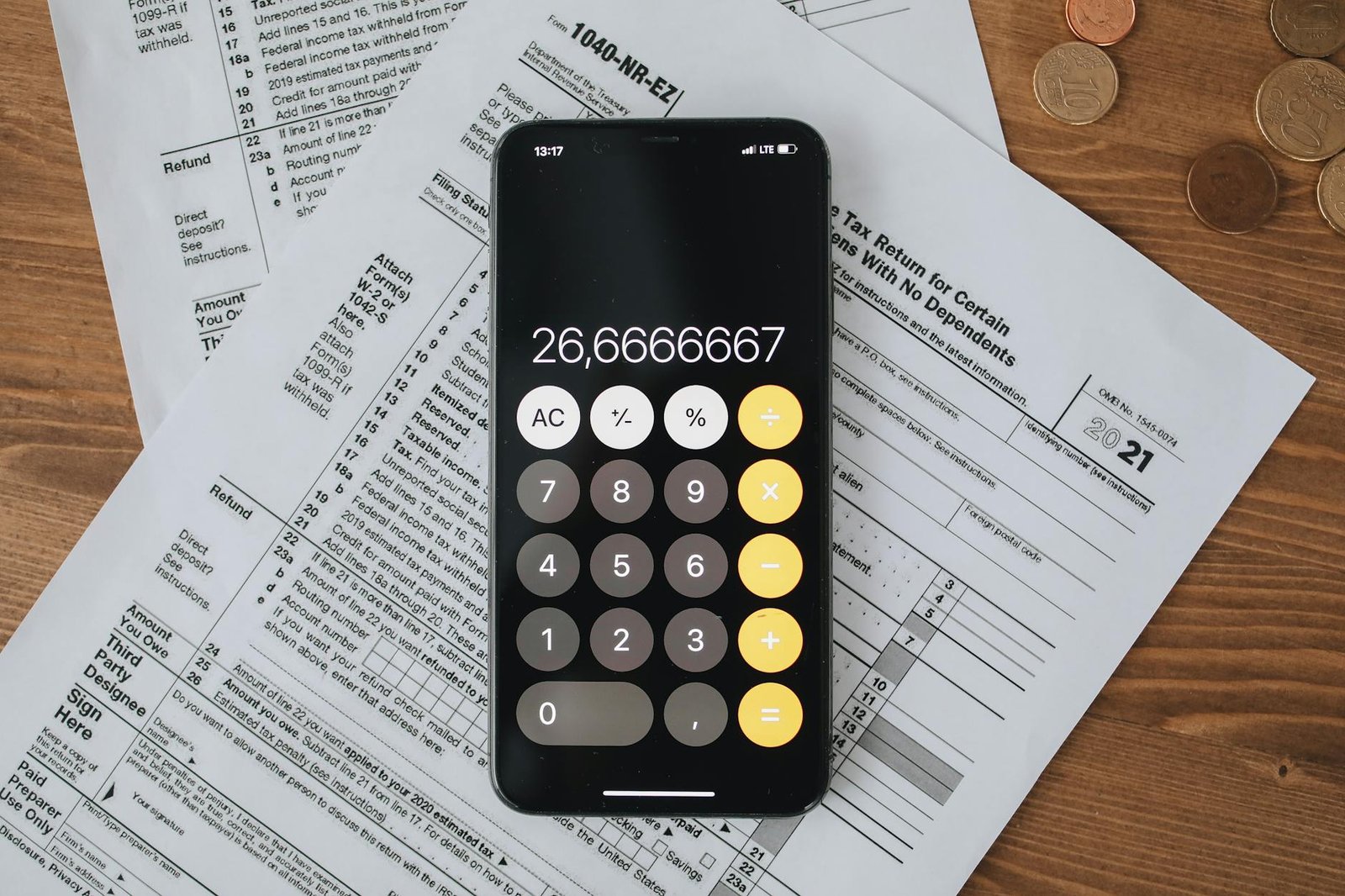 tax forms with calculator on wooden surface