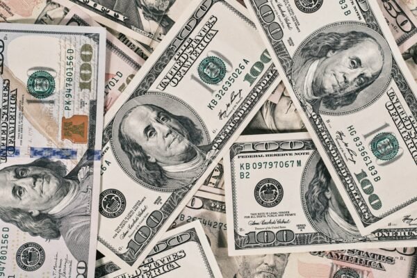 a pile of twenty dollar bills laying on top of each other